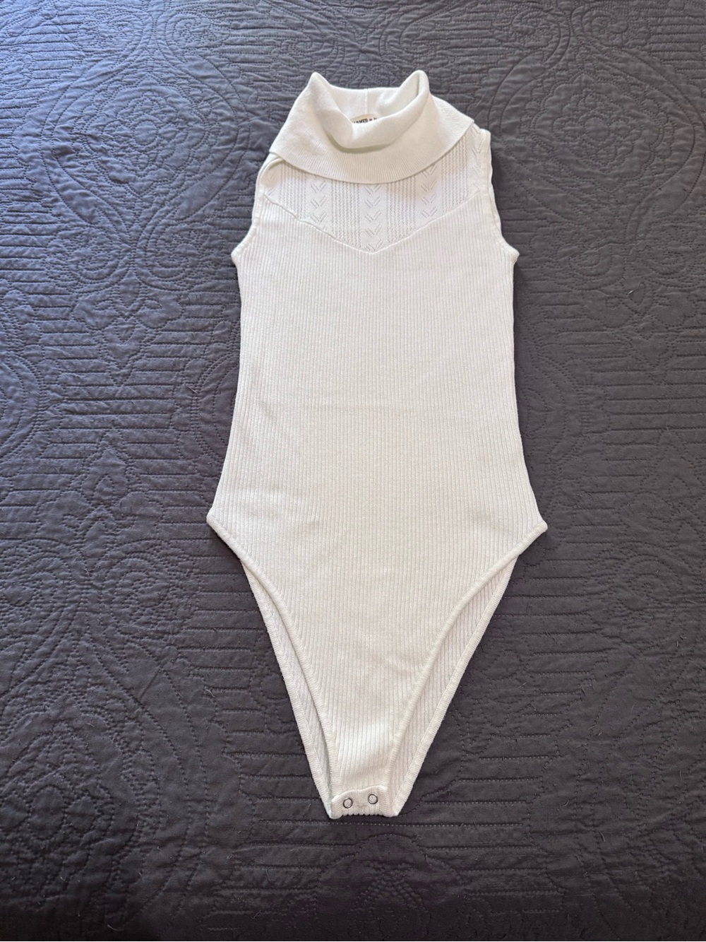 Sleeveless Cream Turtleneck One-Piece Bodysuit.